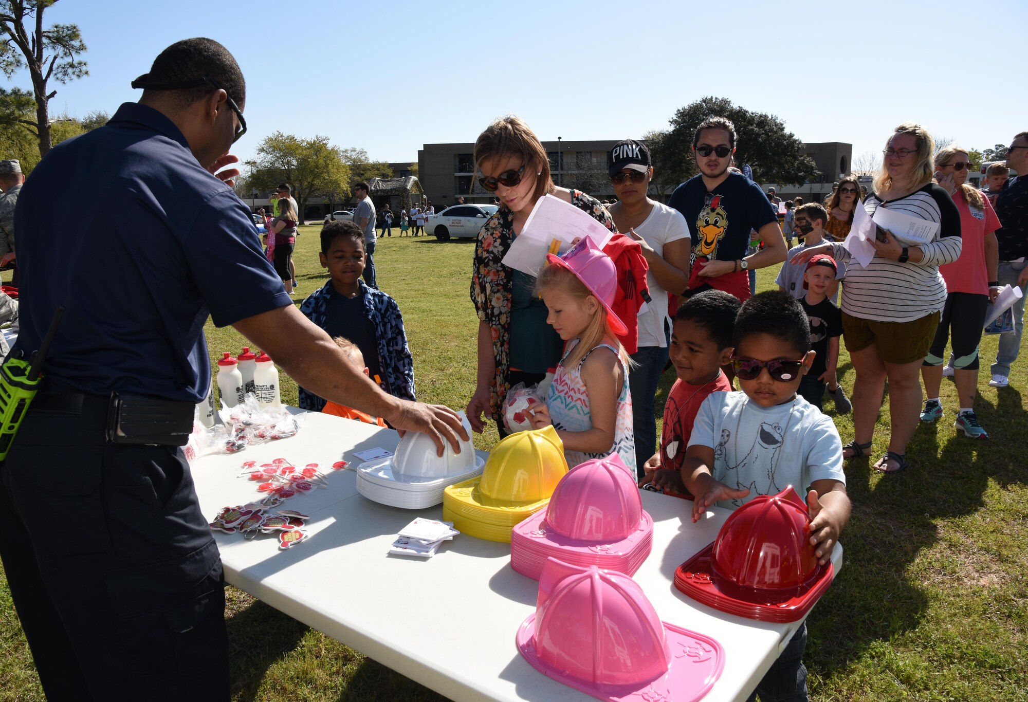 John McIntyre, 81st Infrastructure Division firefighter, provides fire safety instructions and handouts to Keesler families during Operation Hero March 18, 2017, on Keesler Air Force Base, Miss. The activities at the event were designed to help children better understand what their parents do when they deploy. (U.S. Air Force photo by Kemberly Groue)