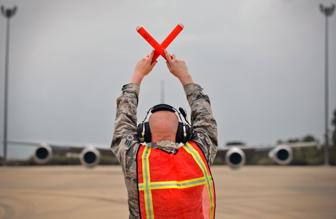 U.S. Air Force Senior Airman Keiven Polm, 100th Aircraft Maintenance Squadron KC-135 Stratotanker crew chief, marshals a KC-135 Stratotanker off the flightline March 16, 2017, at Naval Station Rota, Spain. The 100th ARW Airmen are currently providing air refueling support for French Forces combat operations in Mali and North Africa. (U.S. Air Force photo by Senior Airman Christine Halan) 