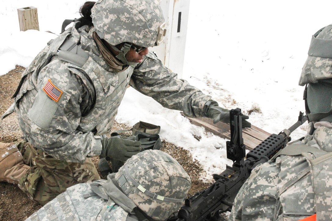 An Army reservist closes the cover of an M240B machine gun after performing a weapons system check during Operation Cold Steel at Fort McCoy, Wis., March 13, 2017. Army Reserve photo by Staff Sgt. Debralee Best 