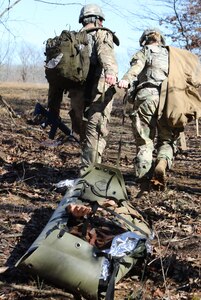 Sgt. Timothy Patino, a combat medic with 1st Battalion, 327th Infantry Regiment, 1st Brigade Combat Team, 101st Airborne Division, and Pfc. Taylor Bannister, health care specialist with 39th Brigade Engineer Battalion, 2nd Brigade Combat Team, evacuate a simulated casualty during Brigade Combat Team Trauma Training on Fort Campbell, Kentucky, Mar. 10, 2017. BCT3 is led by a staff of experts from the U.S. Army Medical Department Center and School at Joint Base San Antonio-Fort Sam Houston.