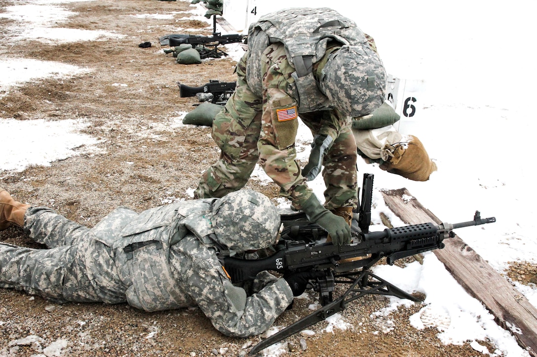 An Army range safety officer loads rounds into an M240B machine gun for zero and qualification during Operation Cold Steel at Fort McCoy, Wis., March 13, 2017. Army Reserve photo by Staff Sgt. Debralee Best 