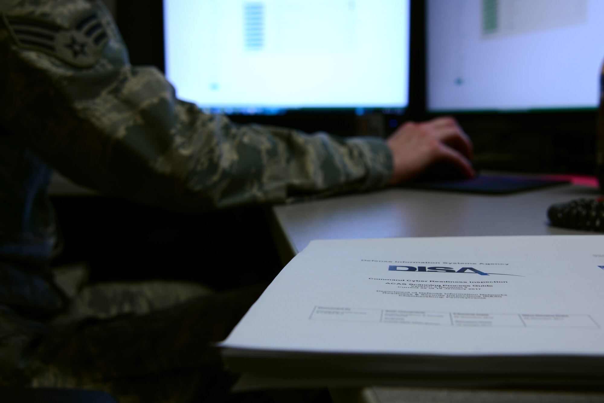 An assured compliance assessment solution guide lies on a desk in a 20th Communications Squadron office at Shaw Air Force Base, S.C., March 15, 2017. The guide, produced by the Defense Information Systems Agency, gives users information about how the program can be used to scan computer networks for vulnerabilities. (U.S. Air Force photo by Airman 1st Class Kathryn R.C. Reaves)