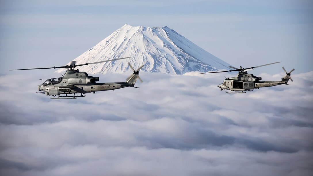 Two Marine Corps helicopters, an AH-1Z Viper and UH-1Y Venom, fly past Mount Fuji, Shizuoka, Japan, March 12, 2017. The helicopters are assigned to Marine Light Attack Helicopter Squadron 267, which is supporting Marine Aircraft Group 36, 1st Marine Aircraft Wing and 3rd Marine Expeditionary Force. The Marines validated the long-range capability of auxiliary fuel tanks on their H-1 platform helicopters by flying 314 nautical miles during one leg of the four-day mission. The  extended range is crucial to maintaining a stronger, more capable forward-deployed force in the Indo-Asia-Pacific region.  Marine Corps photo by Lance Cpl. Andy Martinez