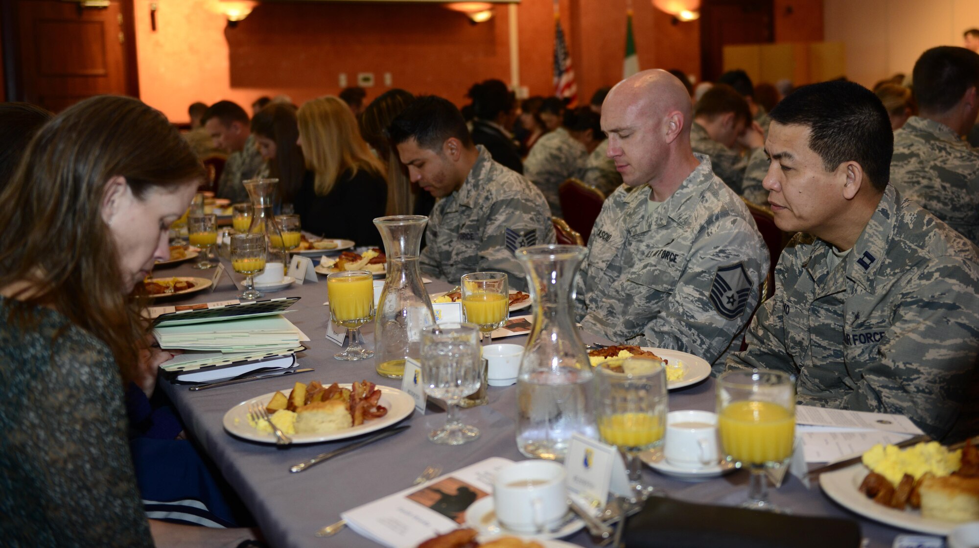 National Prayer Breakfast attendees pause for prayer at Aviano Air Base, Italy, March 20, 2017. The event featured various religious text readings and a speech from Maj. Gen. Dondi Costin, U.S. Air Force chief of chaplains. (U.S. Air Force photo by Staff Sgt. Krystal Ardrey)