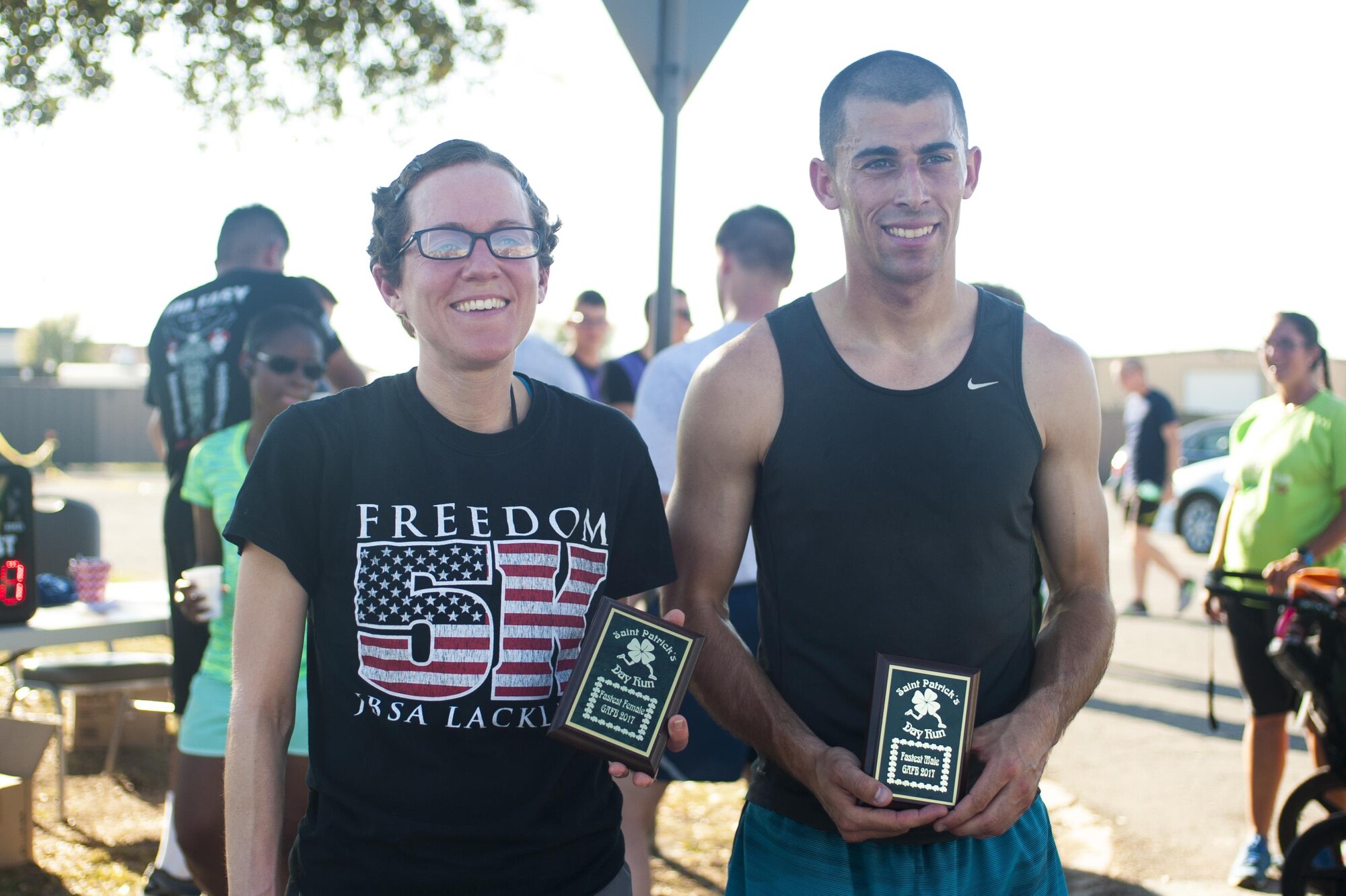 U.S. Air Force Airman 1st Class Bretta Jones, 316th Training Squadron student, and Airman 1st Class Jacob Bull, 312th Training Squadron student, show their trophies for winning the St. Patrick ‘s day fun-run on Goodfellow Air Force Base, Texas, March 17th, 2017. Bull trains in his off time for marathons. (U.S. Air Force photo by Senior Airman Scott Jackson/Released)