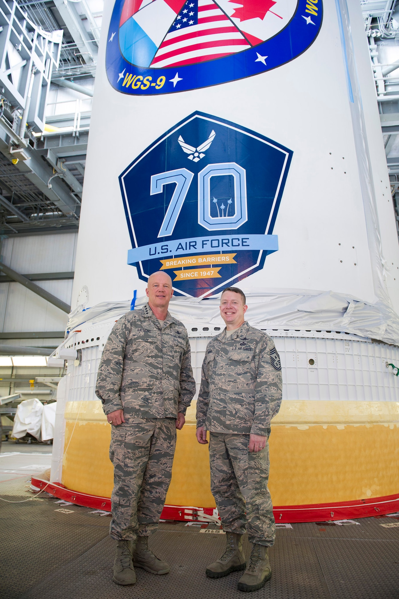 Gen. Jay Raymond, commander of Air Force Space Command and Chief Master Sgt. Brendan Criswell, AFSPC command chief, March 8, 2017, stand in front of a Delta IV at Space Launch Complex 37, at Cape Canaveral Air Force Station, Fla. The tour included a close up of the WGS-09 payload, which adorned the 70th Anniversary U.S. Air Force Breaking Barriers emblem. (U.S. Air Force photo/Matthew Jurgens)  