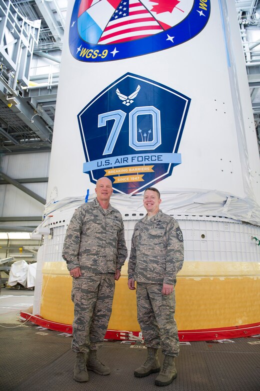 Gen. Jay Raymond, commander of Air Force Space Command and Chief Master Sgt. Brendan Criswell, AFSPC command chief, March 8, 2017, stand in front of a Delta IV at Space Launch Complex 37, at Cape Canaveral Air Force Station, Fla. The tour included a close up of the WGS-09 payload, which adorned the 70th Anniversary U.S. Air Force Breaking Barriers emblem. (U.S. Air Force photo/Matthew Jurgens)  