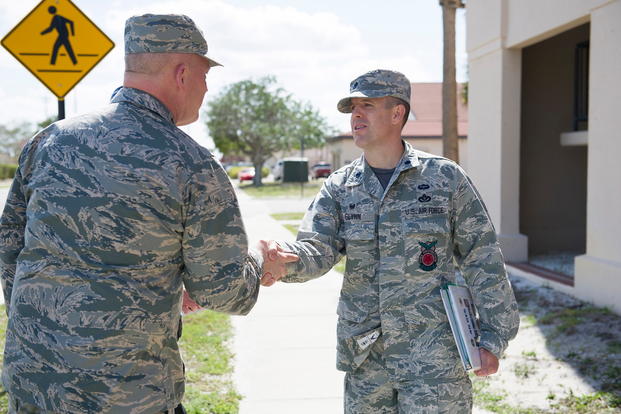 Gen. Jay Raymond, commander of Air Force Space Command, shakes hands with Lt. Col. Jason Glynn, 45th Civil Engineer Squadron commander, during a tour of Patrick Air Force Base, Fla. March 8, 2017. Members of the 45th CES showed Raymond the significant upgrades to the infrastructure here to include the dormitory, fitness center, and the military working dog obedience yard.  (U.S. Air Force photo/Matthew Jurgens)