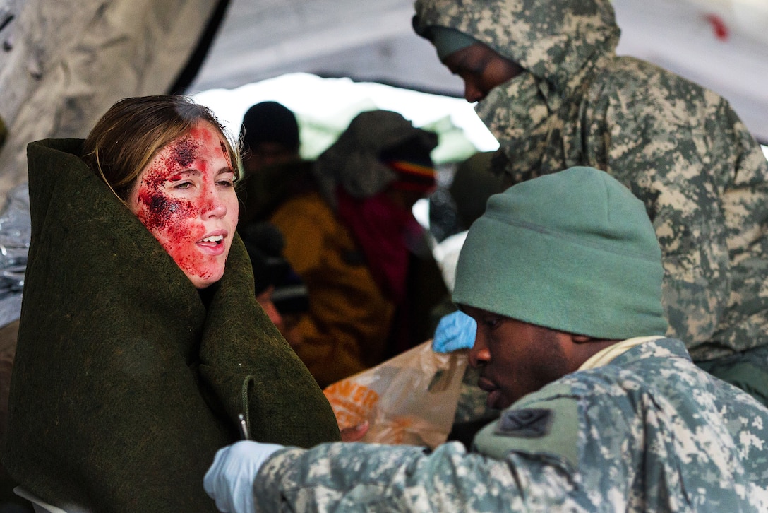 South Carolina Army National Guard Spc. Keenan Summers, foreground, provides medical aid for a mock patient during a U.S. Army North joint training exercise in Owings Mills, Md., March 10, 2017. Summers is a medic assigned to the South Carolina Army National Guard’s 251st Area Support Medical Company. Air National Guard photo by Tech. Sgt. Jorge Intriago 