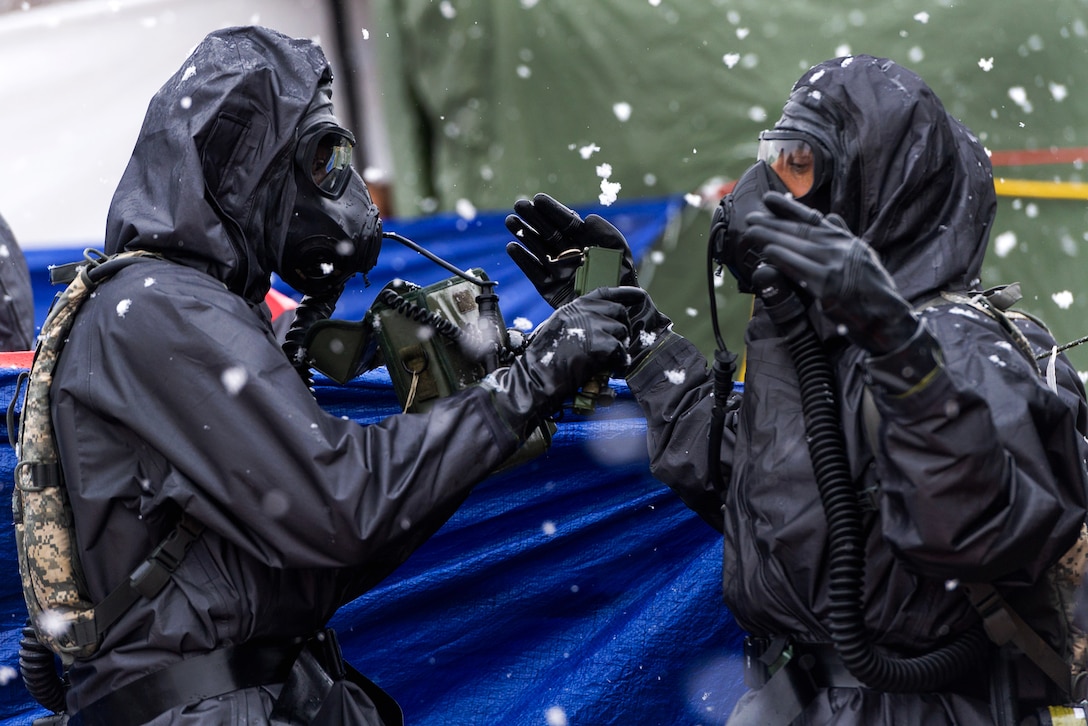 A Maryland Army National Guard member checks a team member’s chemical gear during a U.S. Army North joint training exercise in Owings Mills, Md., March 10, 2017. Air National Guard photo by Tech. Sgt. Jorge Intriago