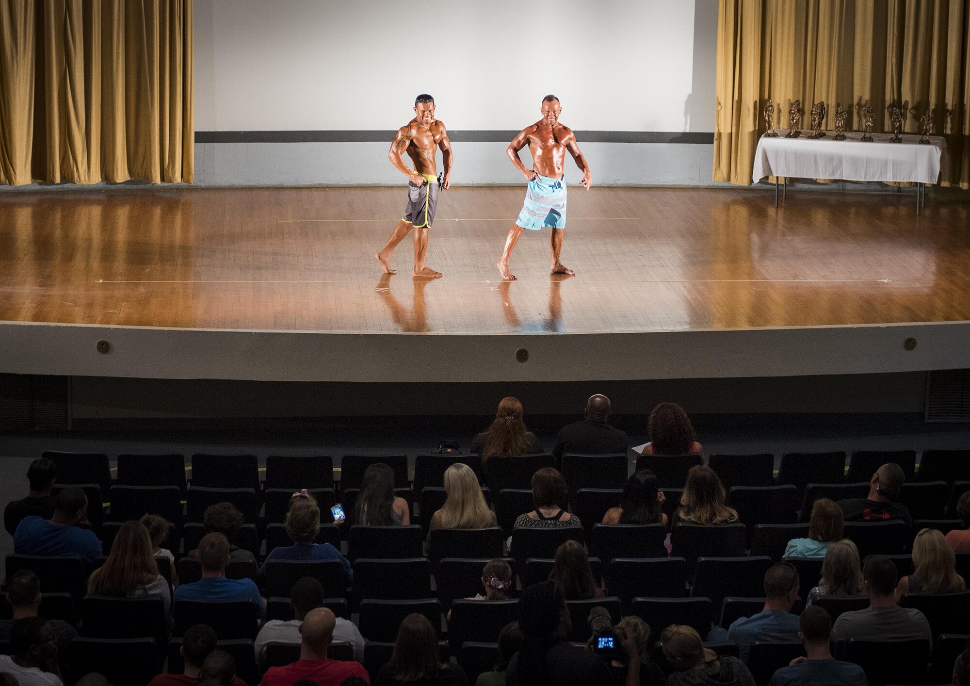 Bodybuilding competitors strike poses during Men's Physique  category judging at the Eglin Bodybuilding Classic contest March 18 at Eglin Air Force Base, Fla.  Four men and 10 women competed in various categories highlighting their fit and sculpted physiques. (U.S. Air Force photo/Samuel King Jr.)