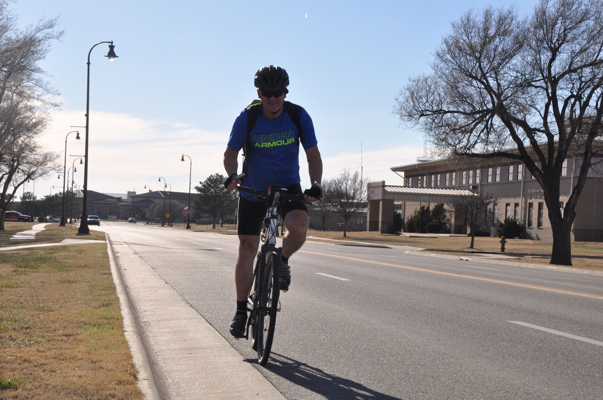 Lt. Col. Clint Burpo, 931st Air Refueling Wing Chief of Logistics Plans and Integration, pedals through Kansas Street Feb. 22, 2017, McConnell Air Force Base.  Burpo has continued rides his bicycle to work almost every day, and has logged 31,000 miles.  (U.S. Air Force photo by Tech. Sgt. Abigail Klein)