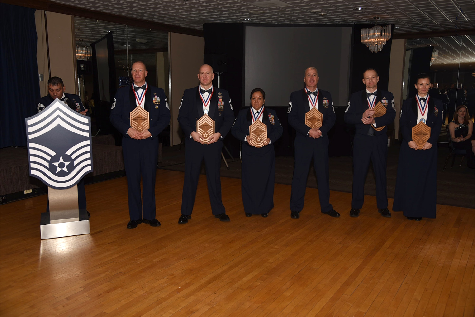 PETERSON AIR FORCE BASE, Colo. – Newly promoted Chief Master Sgts. receive plaques during the Chief’s Induction Ceremony  March 17, 2017 at The Club, Peterson Air Force Base, Colo. Plaques are given annually to the newly promoted chief’s as a memento by the Colorado Springs Area Chief’s Group to remember the event. (U.S. Air Force photo by Robb Lingley)