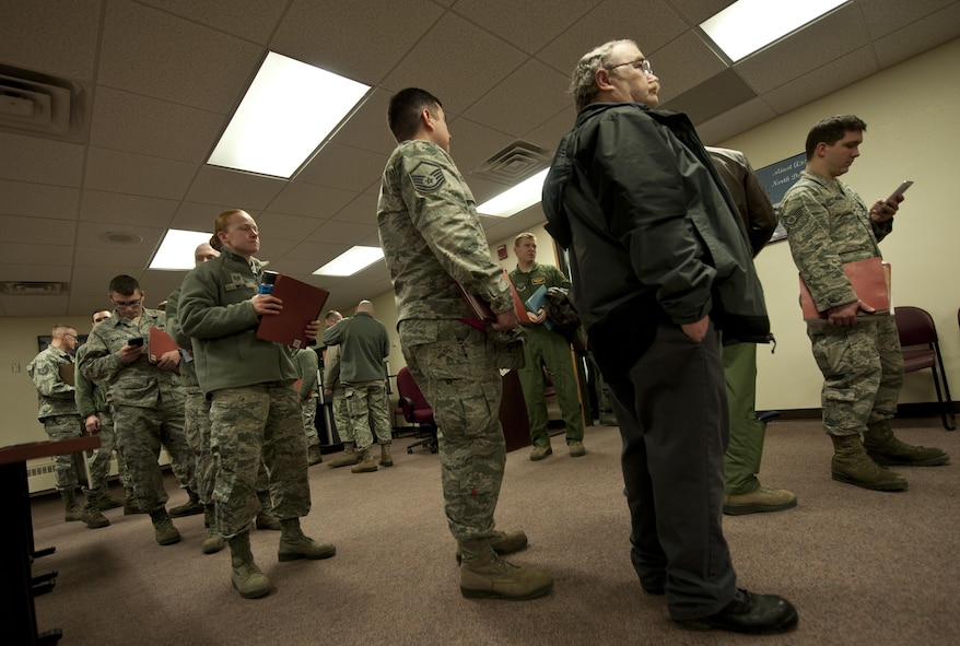Deployers wait in a personnel deployment function line at Minot Air Force Base, N.D., Feb. 23, 2017. Prior to their departure, each deployer must go through a PDF line, which inspects all of their deployment required paperwork. (U.S. Air Force photo/Airman 1st Class Jonathan McElderry)