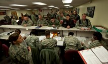 Deployers go through a personnel deployment function line at Minot Air Force Base, N.D., Feb. 23, 2017. Prior to their departure, each deployer must go through a PDF line, which inspects all of their deployment required paperwork. (U.S. Air Force photo/Airman 1st Class Jonathan McElderry)