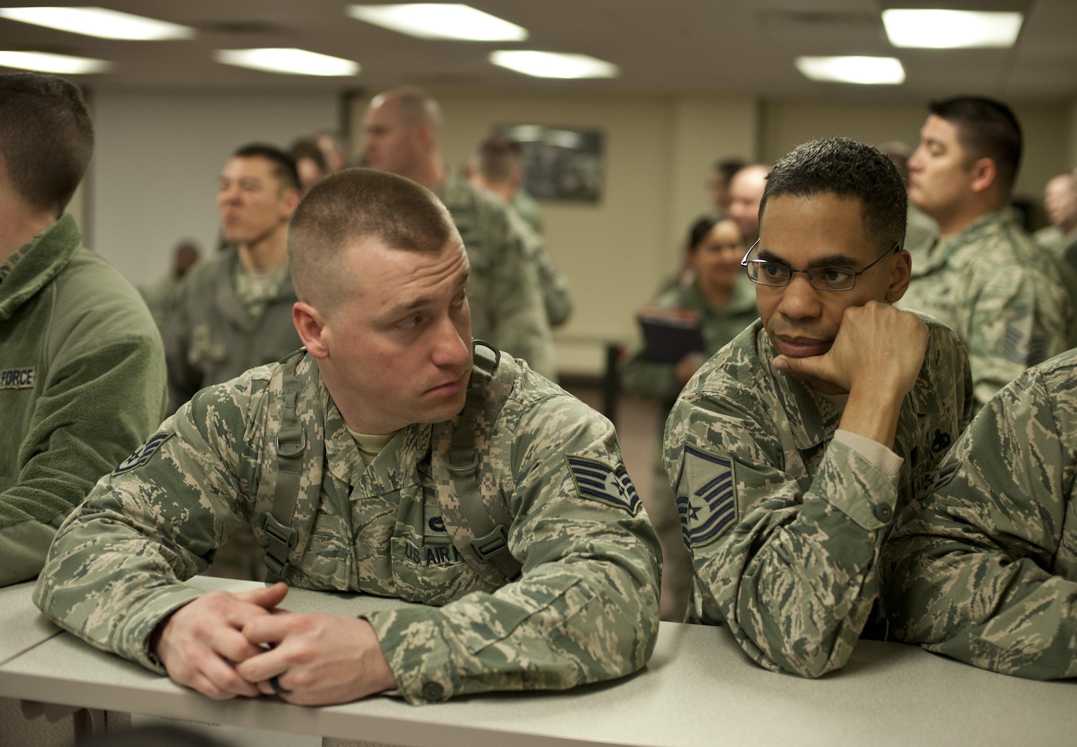 (From left) Staff Sgt. Woodrow Short, 5th Munitions Squadron support section supervisor, is aided by Master Sgt. Bryce Davis, 5th Maintenance Group unit deployment manager, at Minot Air Force Base, N.D., Feb. 23, 2017. The personnel deployment function line provides services from various units including the 5th Force Support Squadron, medical, chapel and finance. (U.S. Air Force photo/Airman 1st Class Jonathan McElderry)