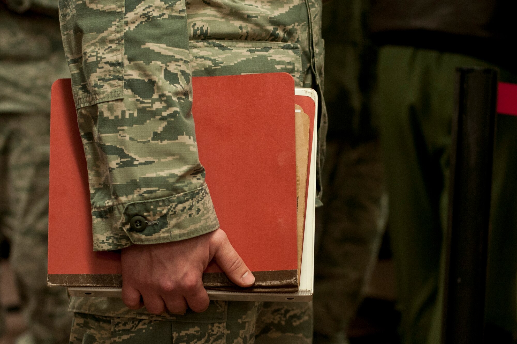 An Airman with the 5th Munitions Squadron holds a deployment folder at Minot Air Force Base, N.D., Feb. 23, 2017. The personnel deployment function line provides services from various units including the 5th Force Support Squadron, medical, chapel and finance. (U.S. Air Force photo/Airman 1st Class Jonathan McElderry)