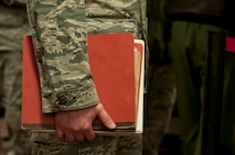 An Airman with the 5th Munitions Squadron holds a deployment folder at Minot Air Force Base, N.D., Feb. 23, 2017. The personnel deployment function line provides services from various units including the 5th Force Support Squadron, medical, chapel and finance. (U.S. Air Force photo/Airman 1st Class Jonathan McElderry)