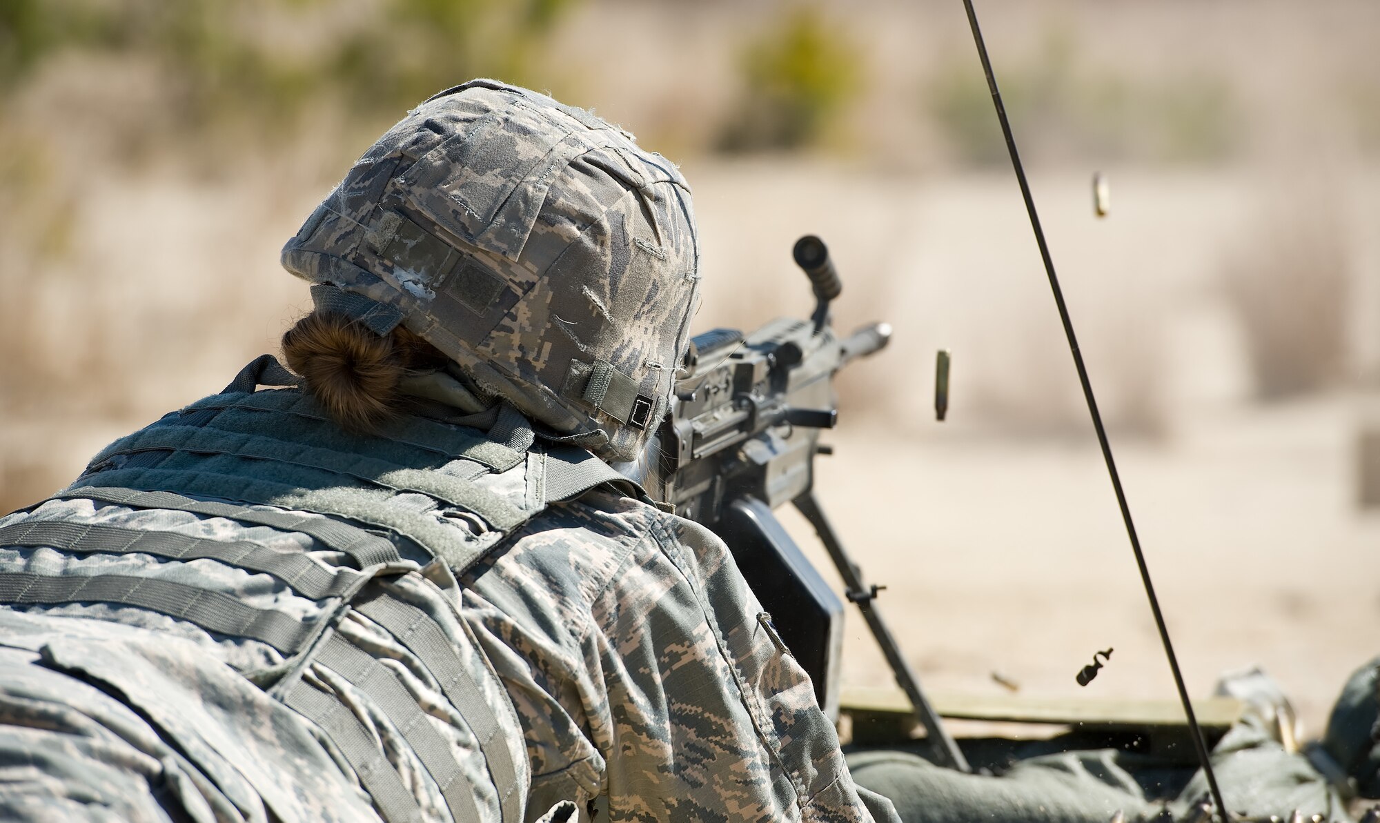 Airman 1st Class Annamae Prentiss, 436th Security Forces Squadron response force member, fires a M-249 Light Machine Gun at decommissioned tanks used as targets at Range 7 on Joint Base McGuire-Dix-Lakehurst, N.J., March 9, 2017. Prentiss and three other 436th SFS members from Dover Air Force Base, Del., took turns firing the M-249 at the tanks placed placed at various distances between 200 to 1,200 meters. (U.S. Air Force photo by Roland Balik)