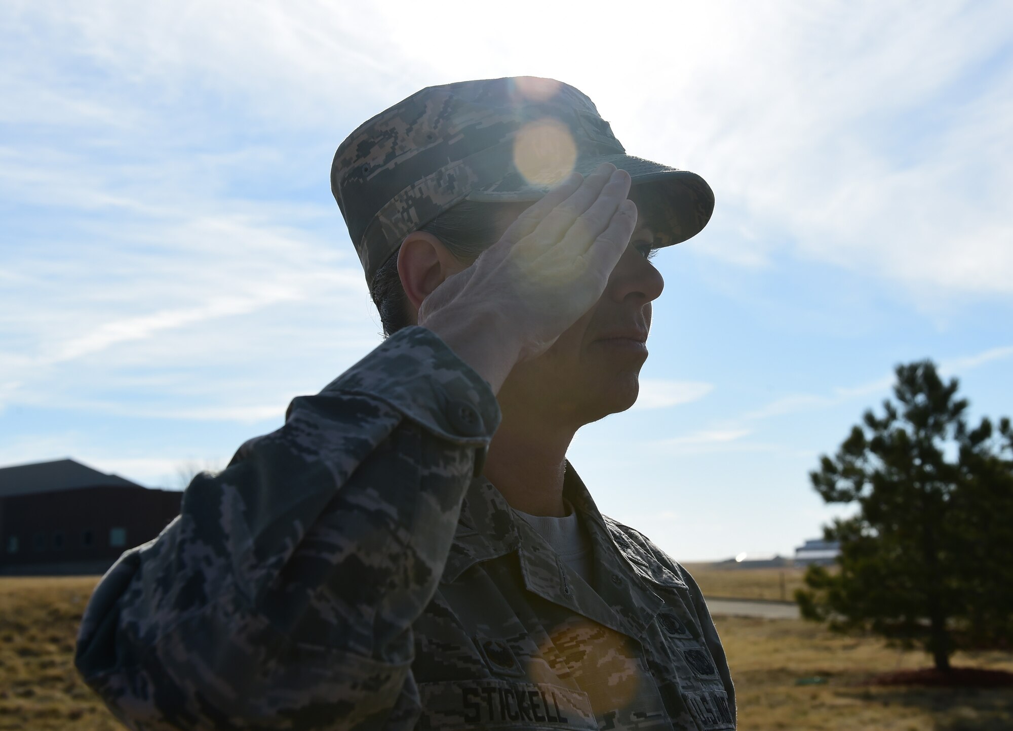 Col. Carolyn Stickell, Headquarters Individual Reservist Readiness and Integration Organization commander, renders a final salute to Senior Airmen Tien Tran, 566th Intelligence Squadron, March 21, 2107, on Buckley Air Force Base, Colo. Tran was tragically killed in a snowboarding accident earlier this month. Members of Team Buckley paid their last respects to Tran and his family at a funeral procession on Buckley AFB. (U.S. Air Force photo by Airman Jacob Deatherage/Released)