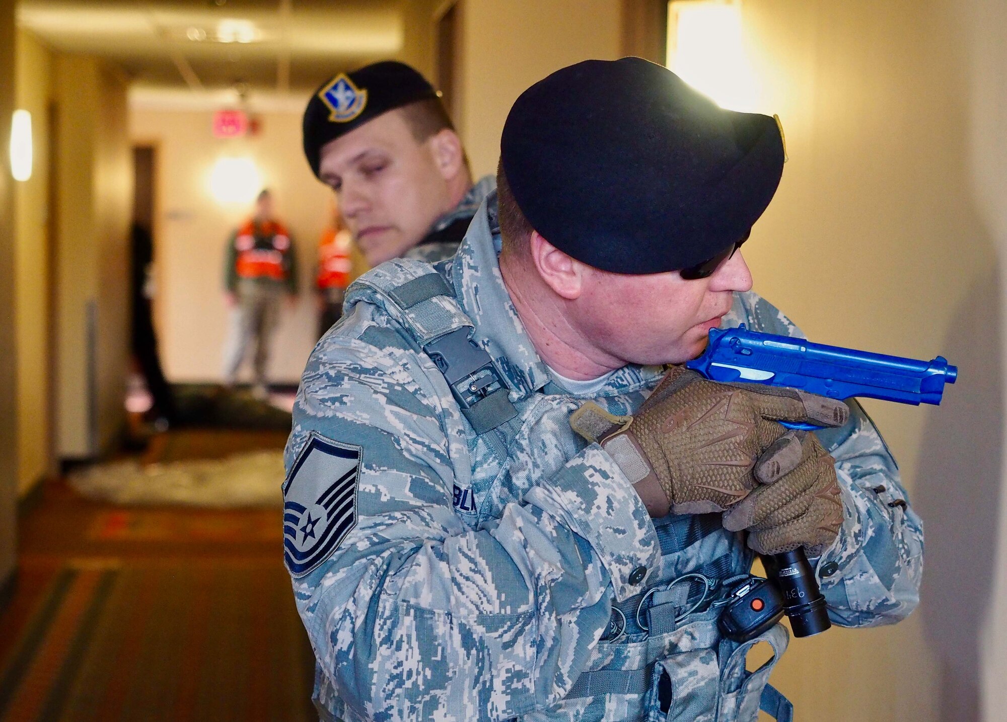 Master Sgt. Chris Blackledge scans the hallway for additional shooters.