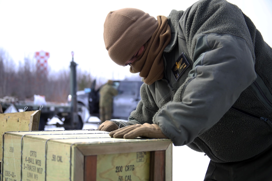 Cpl. Cade Mierstice opens a box of ammunition to load aircraft for cold weather flight operations aboard Ft. Drum, N.Y., Mar. 11, 2017. After being an avid competitor in wrestling, he chose to join the Marine Corps because he did not want to settle for anything short of the finest. “We’re the best,” said Mierstice. “It’s just how we are. I was a state championship wrestler before I got in, and I always wanted to be the best at everything I did.” Mierstice is an aviation ordnance technician with Marine Light Attack Helicopter Squadron 269. (U.S. Marine Corps photo by Cpl. Mackenzie Gibson/Released)