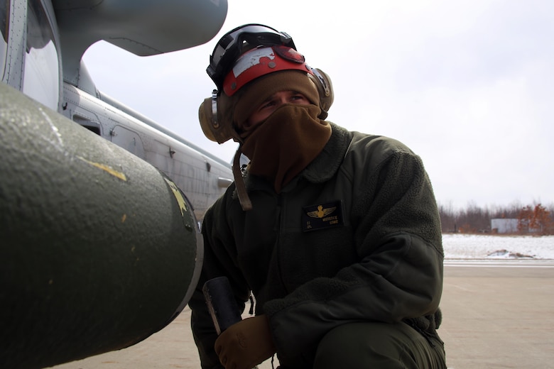 Cpl. Cade Mierstice supervises his Marines as they load aircraft for cold weather flight operations aboard Ft. Drum, N.Y., Mar. 11, 2017. Mierstice states that he tries to lead his Marines by example and never let them do anything that he would not do. “Murphey’s Law is kind of a big thing here,” said Mierstice. “Anything that can go wrong will go wrong. We just have to overcome the obstacles, and we always manage as a team. Mierstice is an aviation ordnance technician with Marine Light Attack Helicopter Squadron 269. (U.S. Marine Corps photo by Cpl. Mackenzie Gibson/Released)