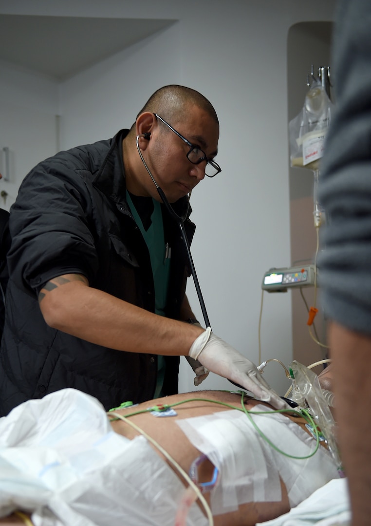 U.S. Army Capt. Sabas Salgado, an Army Institute of Surgical Research nurse, listens to a patient’s lung sounds in a hospital in South America Feb. 16, 2017. Salgado was part of the medical team that transported a patient from South America to the San Antonio Military Medical Center in Texas for further treatment. (U.S. Air Force photo/Staff Sgt. Jerilyn Quintanilla)