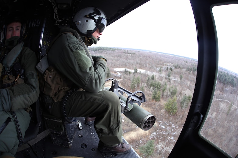 Cpl. Justin Martin watches the skies from the inside a UH-1Y Venom during cold weather operations over Fort Drum, N.Y., March 10, 2017. The training, which began March 8, involves learning how to deal with the challenges that come with working in cold, and sometimes snowy and icy environments. With snowy obstacles and temperatures in the sub-zero range, the Marines will learn how to adapt and overcome. Martin is a flight line mechanic with Marine Light Attack Helicopter Squadron 269, Marine Aircraft Group 29, 2nd Marine Aircraft Wing. (U.S. Marine Corps photo by Cpl. Mackenzie Gibson/Released) 