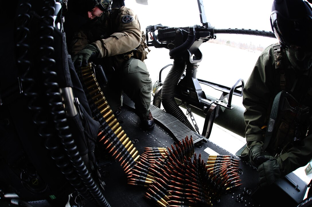 Marines load ordnance on an aircraft during cold weather operations aboard Fort Drum, N.Y., March 11, 2017. The training, which began March 8, involves Marines with Marine Light Attack Helicopter Squadron 269, Marine Aircraft Group 29, 2nd Marine Aircraft Wing, along with other various units across the Department of Defense. The Marines will learn how to deal with the challenges that come with working in cold, and sometimes snowy and icy environments. (U.S. Marine Corps photo by Cpl. Mackenzie Gibson/Released)