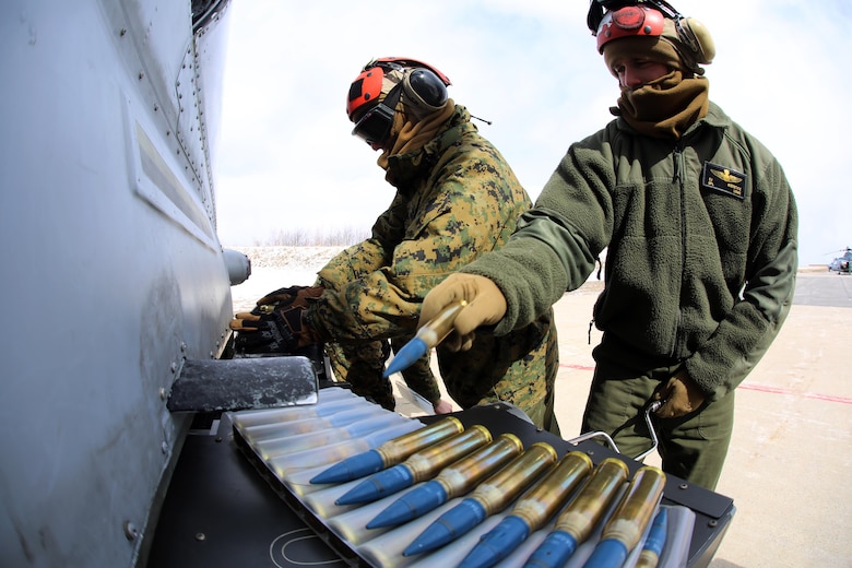 Pfc. Stetson Kirkpatrick (left) and Cpl. Cade Mierstice (right) load ordnance on an aircraft during cold weather operations aboard Fort Drum, N.Y., March 11, 2017. The training, which began March 8, involves Marines with Marine Light Attack Helicopter Squadron 269, Marine Aircraft Group 29, 2nd Marine Aircraft Wing, along with other various units across the Department of Defense. The Marines will learn how to deal with the challenges that come with working in cold, and sometimes snowy and icy environments. Kirkpatrick and Mierstice are aviation ordnance technicians with HMLA-269. (U.S. Marine Corps photo by Cpl. Mackenzie Gibson/Released) 