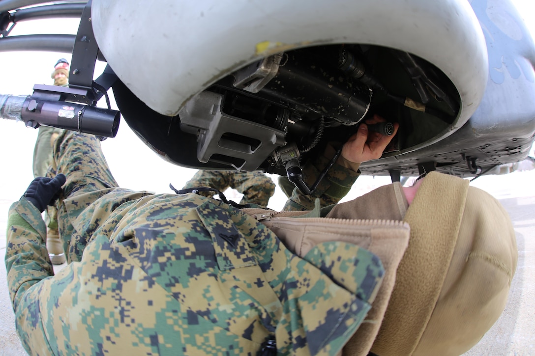 Lance Cpl. Collin Stewart readies an aircraft for cold weather operations aboard Fort Drum, N.Y., March 11, 2017. The training, which began March 8, will involve Marines with Marine Light Attack Helicopter Squadron 269, Marine Aircraft Group 29, 2nd Marine Aircraft Wing, along with other various units across the Department of Defense. The Marines will learn how to deal with the challenges that come with working in cold, and sometimes snowy and icy environments. Stewart is an aviation ordnance technician with HMLA-269. (U.S. Marine Corps photo by Cpl. Mackenzie Gibson/Released)