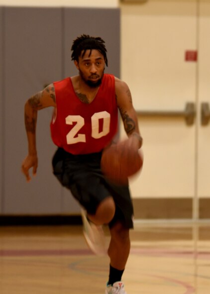 Joseph Peters, Armed Forces Medical Examiner System forward, dribbles the ball down the court during an intramural basketball game March 20, 2017, at the Fitness Center on Dover Air Force Base, Del. Peters was a key player in the game that sent AFMES to the playoffs. (U.S. Air Force photo by Senior Airman Ashlin Federick)