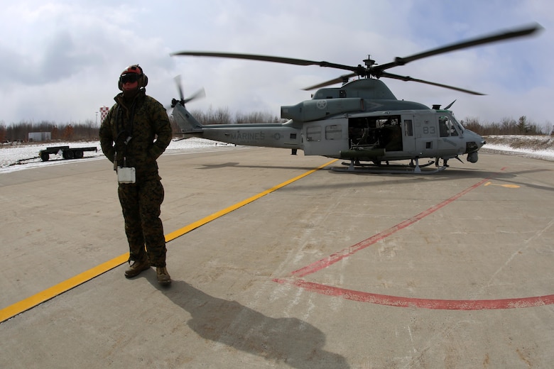 Lance Cpl. Collin Stewart waits to conduct a pre-flight inspection of aircraft weapons systems for cold weather operations aboard Fort Drum, N.Y., March 11, 2017. The training, which began March 8, will involve Marines with Marine Light Attack Helicopter Squadron 269, Marine Aircraft Group 29, 2nd Marine Aircraft Wing, along with other various units across the Department of Defense. The Marines will learn how to deal with the challenges that come with working in cold, and sometimes snowy and icy environments. Stewart is an aviation ordnance technician with HMLA-269. (U.S. Marine Corps photo by Cpl. Mackenzie Gibson/Released)