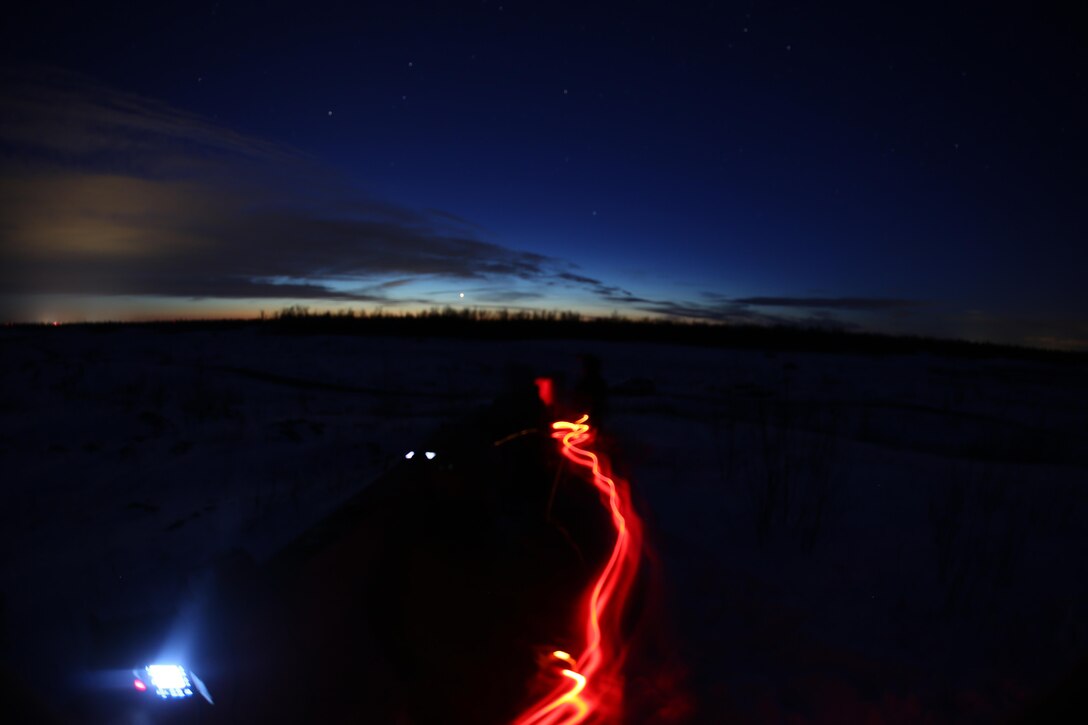 A Marine with a headlamp paces back and forth as he waits to radio in air support during close air support training operations at a range near Fort Drum, N.Y., March 16, 2017. Marines assigned to 1st Air Naval Gunfire Liaison Company, I Marine Expeditionary Force Headquarters Group, I Marine Expeditionary Force, worked in conjunction with Marines assigned to Marine Light Attack Helicopter Squadron 269, Marine Aircraft Group 29, 2nd Marine Aircraft Wing, to complete the training. Without the teamwork between Marines on the ground and Marines in the skies, pilots would have much more difficulty finding their mission objectives. (U.S. Marine Corps photo by Cpl. Mackenzie Gibson/Released)