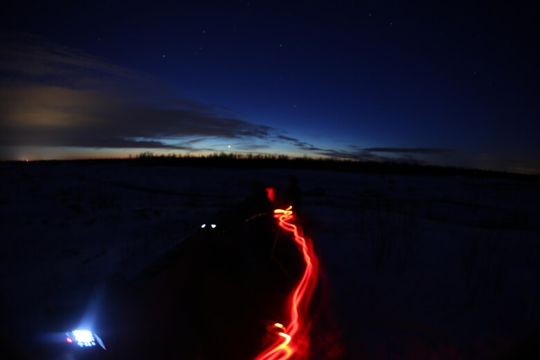 A Marine with a headlamp paces back and forth as he waits to radio in air support during close air support training operations at a range near Fort Drum, N.Y., March 16, 2017. Marines assigned to 1st Air Naval Gunfire Liaison Company, I Marine Expeditionary Force Headquarters Group, I Marine Expeditionary Force, worked in conjunction with Marines assigned to Marine Light Attack Helicopter Squadron 269, Marine Aircraft Group 29, 2nd Marine Aircraft Wing, to complete the training. Without the teamwork between Marines on the ground and Marines in the skies, pilots would have much more difficulty finding their mission objectives. (U.S. Marine Corps photo by Cpl. Mackenzie Gibson/Released)
