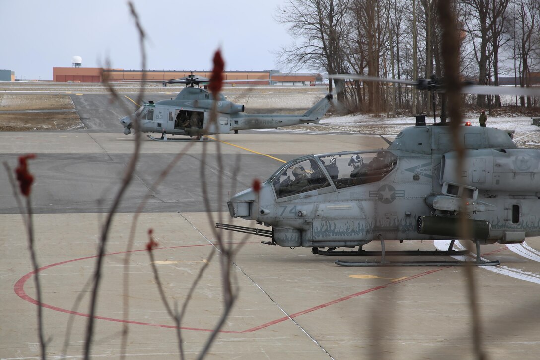 A UH-1Y Venom and an AH-1W Super Cobra prepare for takeoff during cold weather operations aboard Fort Drum, N.Y., March 8, 2017. The training, which began March 8, involves Marines with Marine Light Attack Helicopter Squadron 269, Marine Aircraft Group 29, 2nd Marine Aircraft Wing, along with other various units across the Department of Defense. The Marines will learn how to deal with the challenges that come with working in cold, and sometimes snowy and icy environments. (U.S. Marine Corps photo by Cpl. Mackenzie Gibson/Released)