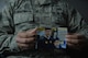 Staff Sgt. Srun Sookmeewiriya, 313th Expeditionary Operations Support Squadron NCO in charge of reports, holds up a picture of him and his younger brother, Thana, on Ramstein Air Base, Germany, Feb. 16, 2017. Sookmeewiriya, who attempted to commit suicide twice, draws inspiration from his brother to remain resilient and encourages Airmen to open up about their struggles.