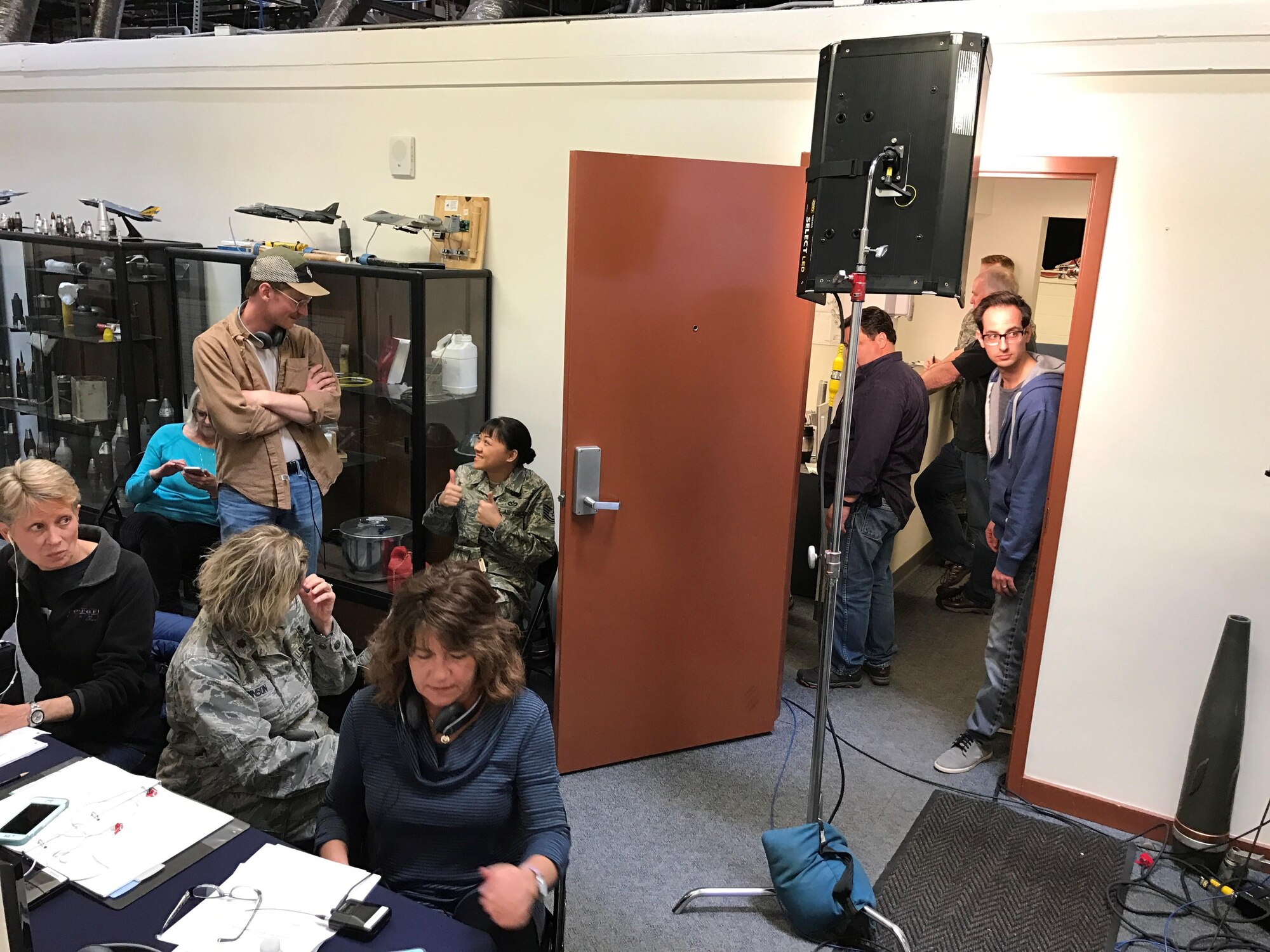 PETERSON AIR FORCE BASE, Colo. – Members of the film crew working with the Center of Excellence for Medical Multimedia from the United States Air Force Academy take a break to review their next scene while preparing to shoot a new scene at the Explosive Ordnance Disposal building at Peterson Air Force Base, Colorado, March 15, 2017. The film crew was shooting a training video addressing how to recognize symptoms of post-traumatic stress disorder and depression in Airmen.  (U.S. Air Force photo by Tech. Sgt. Joshua Arends)  