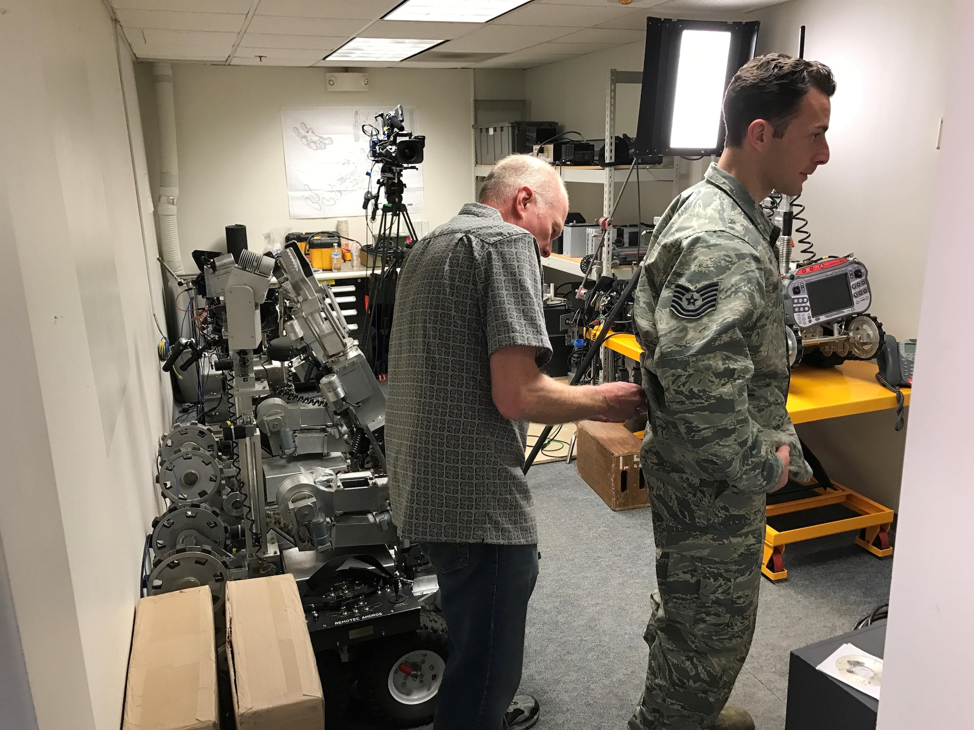 PETERSON AIR FORCE BASE, Colo. – A film crew technician working with the Center of Excellence for Medical Multimedia from the United States Air Force Academy hides the wireless microphone on an actor before filming a scene at the Explosive Ordnance Disposal building at Peterson Air Force Base, Colorado, March 15, 2017. The film crew was shooting a training video addressing how to recognize symptoms of post-traumatic stress disorder and depression in Airmen.  (U.S. Air Force photo by Tech. Sgt. Joshua Arends)