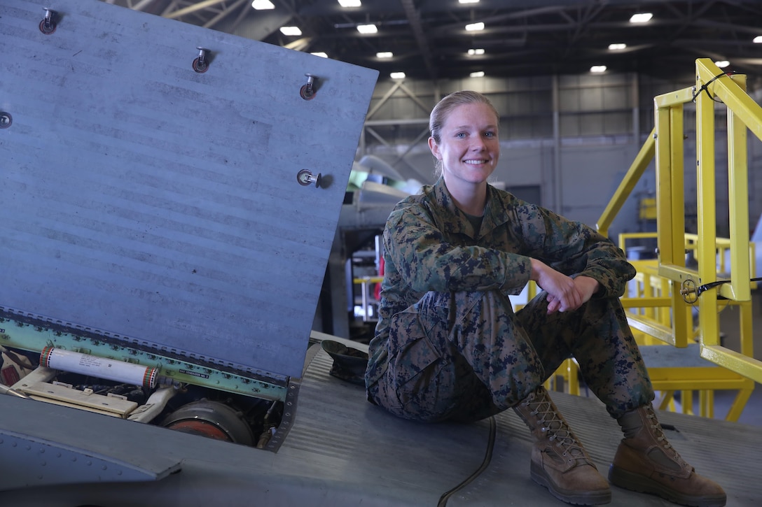 Cpl. Callahan Brown sits atop an aircraft that’s undergoing maintenance at Marine Aviation Logistics Squadron 26 on Marine Corps Air Station New River, Mar 3. Brown is currently a full time student at Coastal Carolina Community College and plans to commission to become an officer when she becomes a sergeant or completes her degree. Brown is the adjutant for MALS 26. (U.S. Marine Corps photo by Lance Cpl. Juan Madrigal)