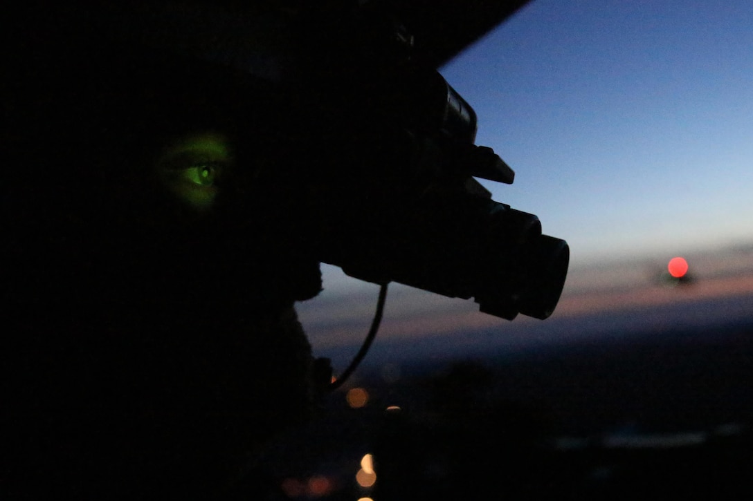 Cpl. Landon Cheek uses his night vision goggles to keep watch out the back of a UH-1Y Venom during night-time cold weather operations aboard Fort Drum, N.Y., March 17, 2017. Marines assigned to Marine Light Attack Helicopter Squadron 269, Marine Aircraft Group 29, 2nd Marine Aircraft Wing, conducted close air support at night with live ordnance to simulate real world operations in a forward position. Cheek is a crew chief with HMLA-269. (U.S. Marine Corps photo by Cpl. Mackenzie Gibson/Released) 