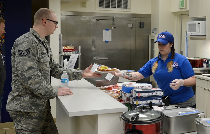 Kate Jones, United Service Organizations Northwest Shali Center volunteer, serves lunch to Staff Sgt. Evan Cooper, 446th Aeromedical Staging Squadron medical technician, Mar. 21, 2017 at Joint Base Lewis-McChord, Wash. The Shali Center and its staff of volunteers stay busy throughout the year serving more than 48,000 troops annually. (U.S. Air Force/Senior Airman Divine Cox)
