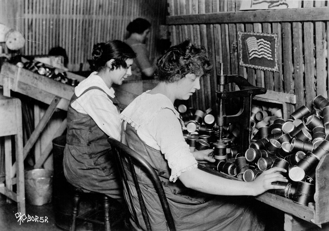 Women make fiber powder containers for the Stokes 3-inch trench mortar on an assembly line at W.C. Ritchie & Co., Chicago, circa 1916. Library of Congress photo