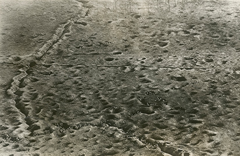 An aerial photograph of a battlefield on the Somme front in France shows French troops moving through trenches and shell craters into an area formerly held by the German army, Jan. 19, 1917. Library of Congress photo
