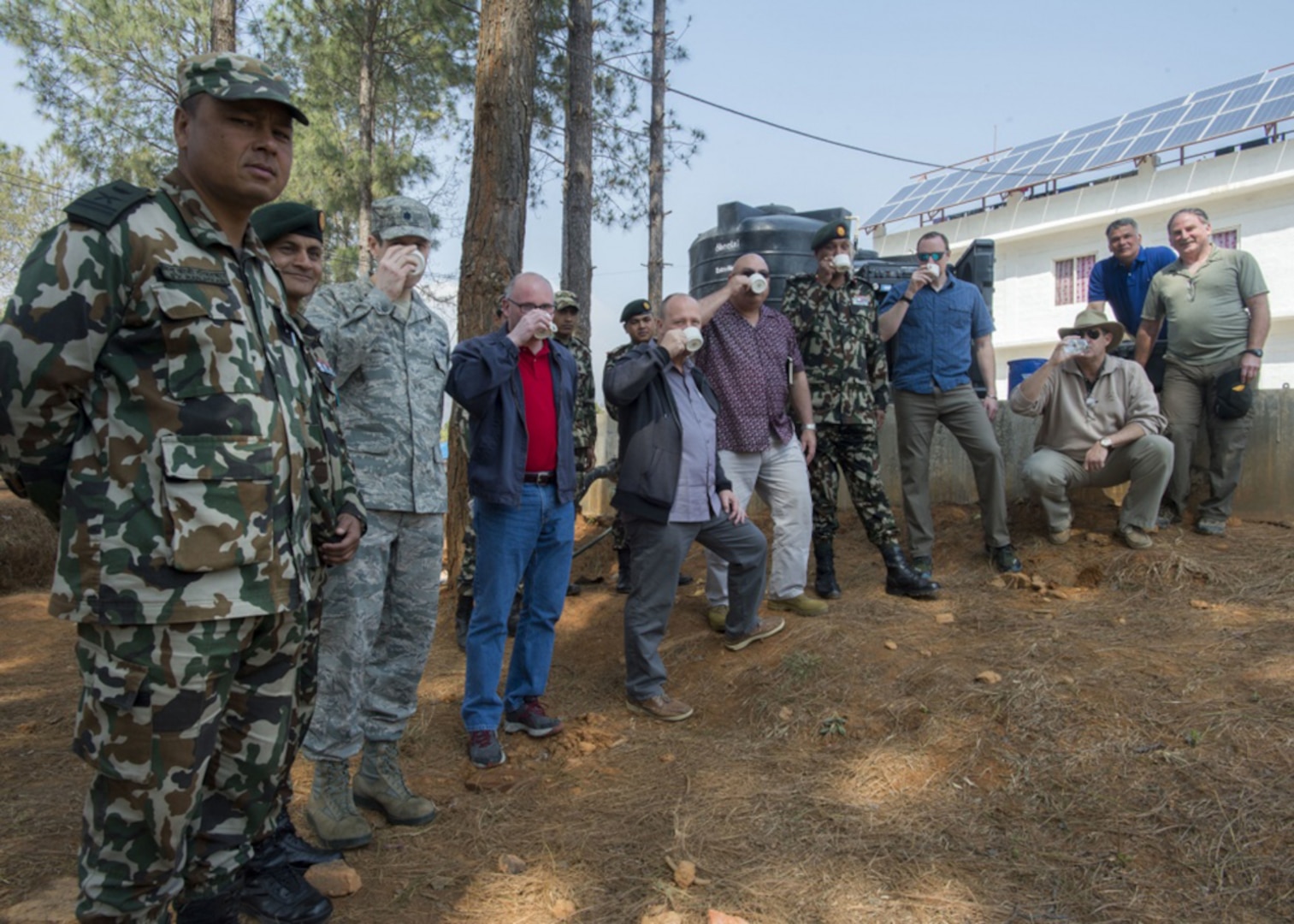 Personnel visiting Nepal’s Birendra Peace Operations Training Centre during Exercise Shanti Prayas III test drinking water purified from a water purification system installed as part of the Net Zero initiative Mar. 21, 2017. The Net Zero initiative, which focuses on power, water and waste remediation, is a pilot program which relies on the usage of solar power with minimum generator back up as an option to be more self-sufficient. With this initiative, the BPOTC, now armed with a water purification system using these energy options, can now produce nearly 5,000 gallons of clean water per day.