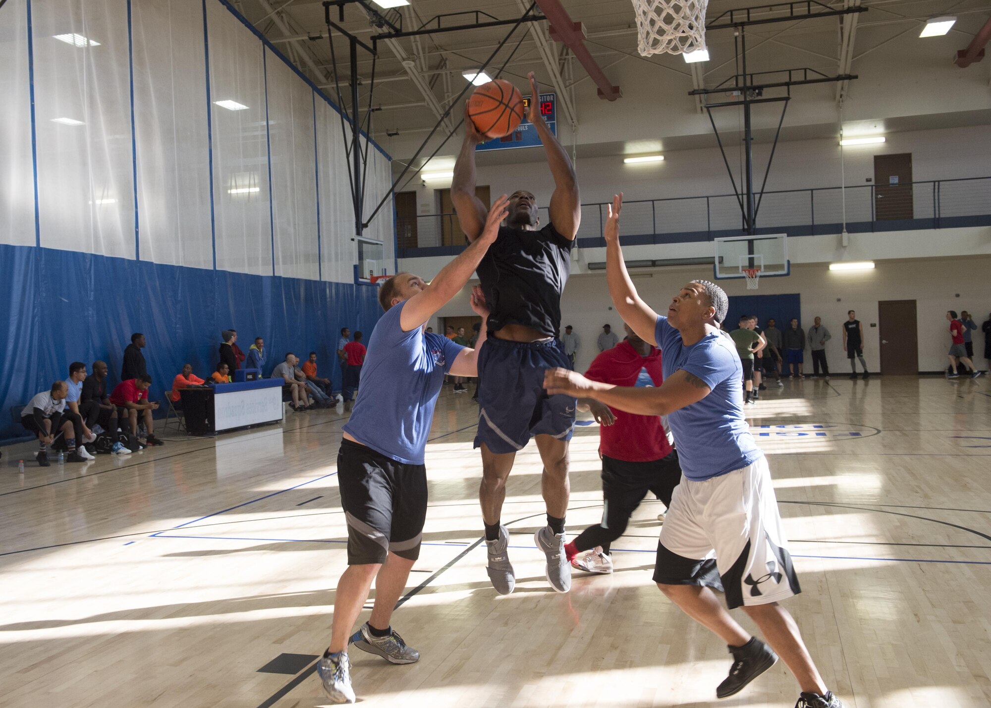 Airmen play a game of basketball during the 49th Wing Sports Day, March 17, 2017 at Holloman Air Force Base, N.M. Sports Day started off with a wing run, and continued with a number of events including volleyball, basketball, dodgeball and many more. (U.S. Air Force photo by Senior Airman Emily Kenney)