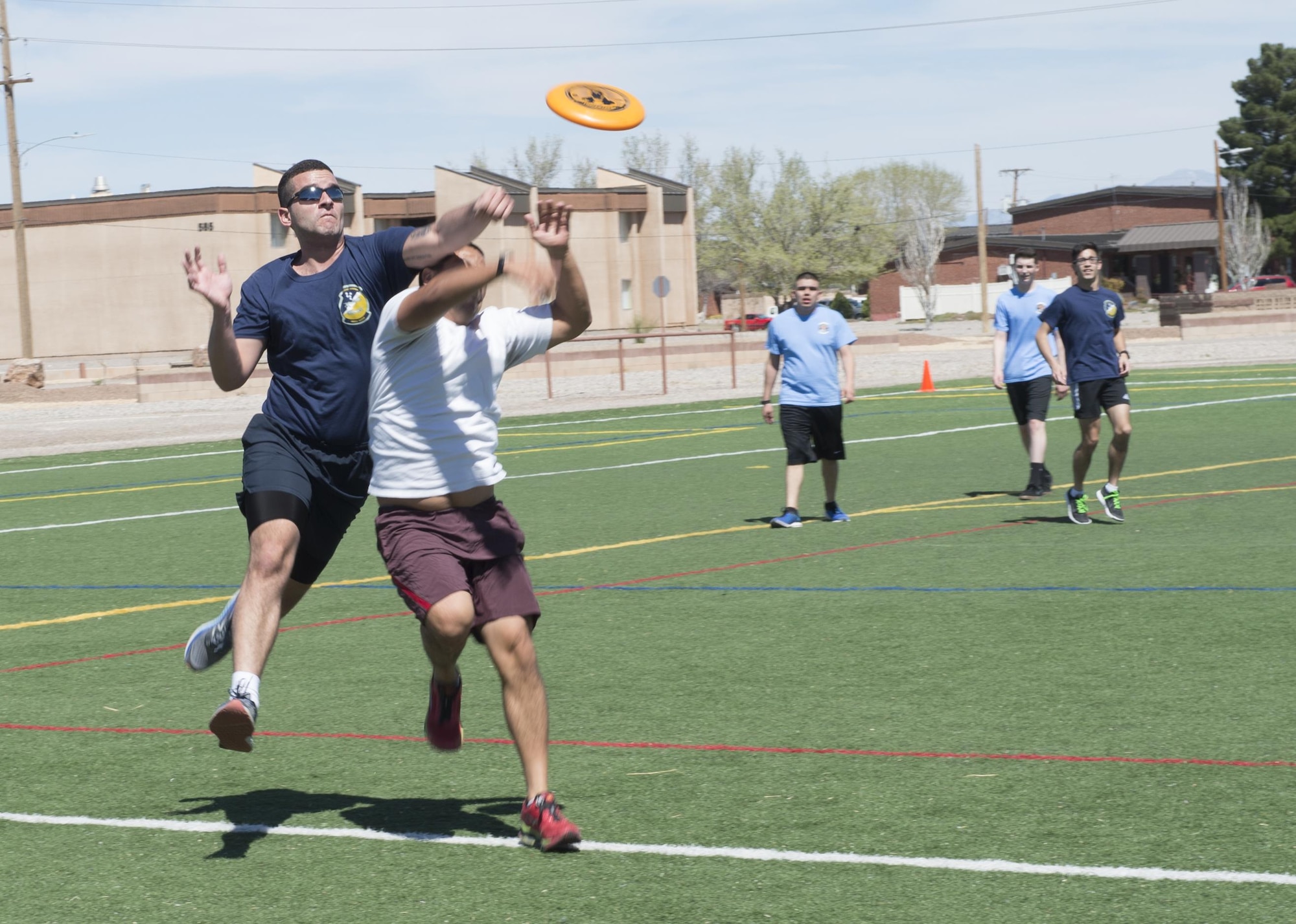 Airmen play a game of ultimate Frisbee during the 49th Wing Sports Day, March 17, 2017 at Holloman Air Force Base, N.M. During Sports Day, squadrons showed their pride and camaraderie during sports such as football, ultimate Frisbee, softball and many more. (U.S. Air Force photo by Senior Airman Emily Kenney)