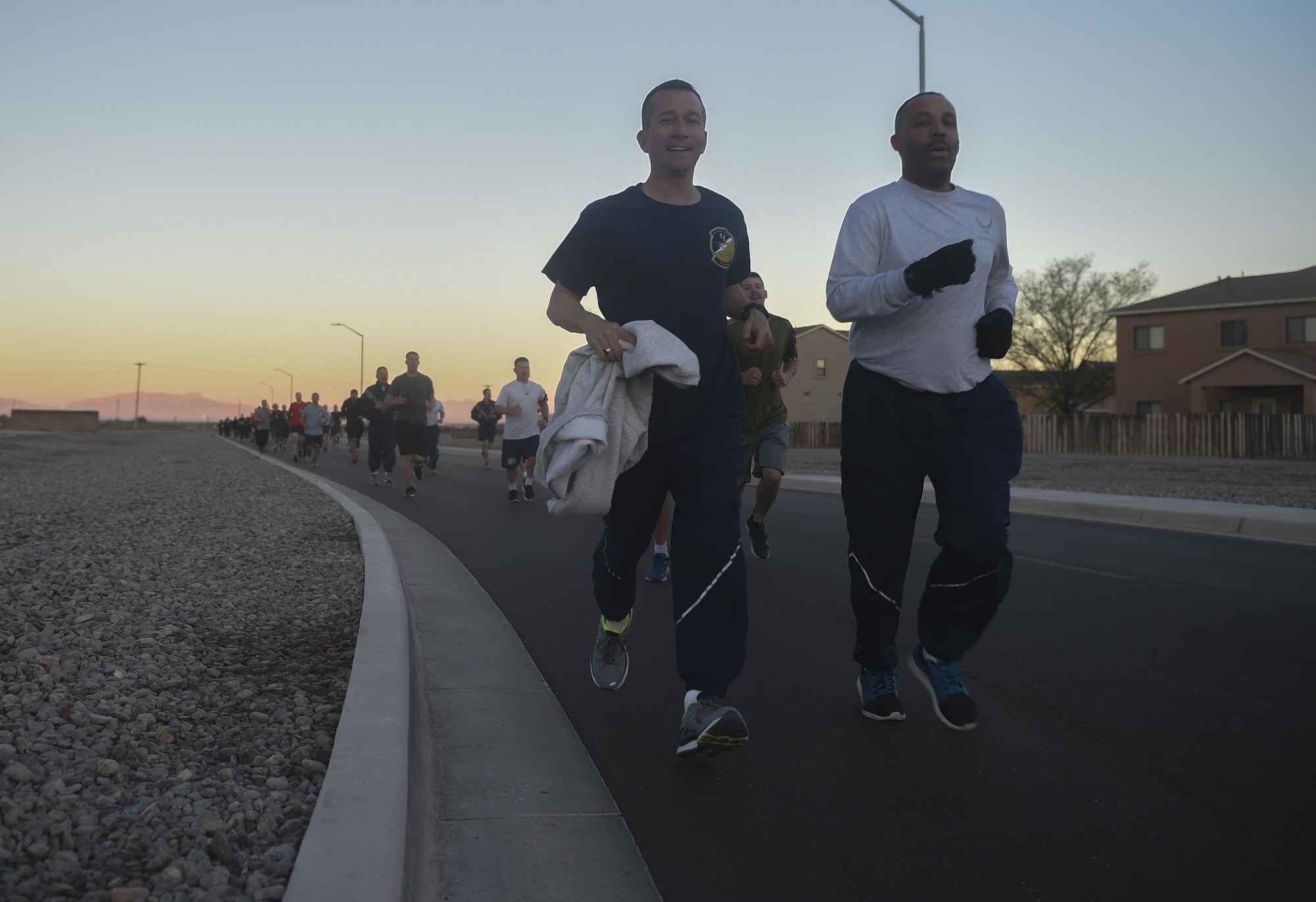 Col. Houston Cantwell, the 49th Wing commander, and Chief Master Sgt. Barrington Bartlett, the 49th Wing command chief, lead Airmen during a 5K run, March 17, 2017 at Holloman Air Force Base, N.M. The run was the first event for the 49th Wing Sports Day. Participants had the option to run either a 1.5 mile route or a 5K route. (U.S. Air Force photo by Staff Sgt. Eboni Prince)