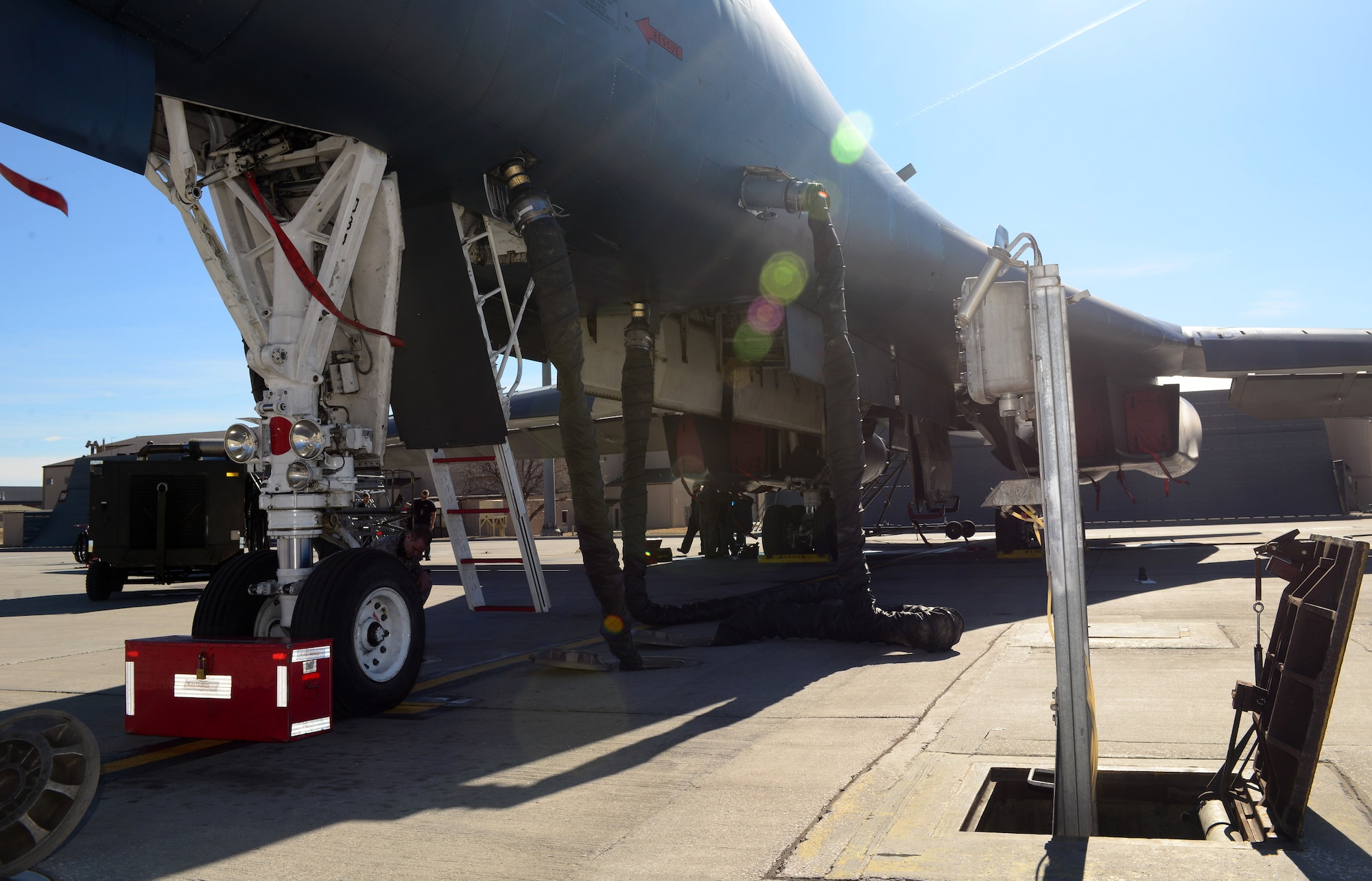 A B-1 bomber is hooked up to the Consolidated Aircraft Support System at Ellsworth Air Force Base, S.D., March 16, 2017. The CASS is made up of multiple structures and parts beneath the flight line used to provide both air and power to support the B-1 during pre-flight inspections. (U.S. Air Force photo by Airman 1st Class Donald C. Knechtel)